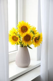 Bouquet of beautiful sunflowers on window sill indoors