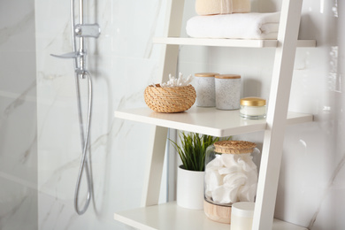 Shelving unit with toiletries in bathroom interior