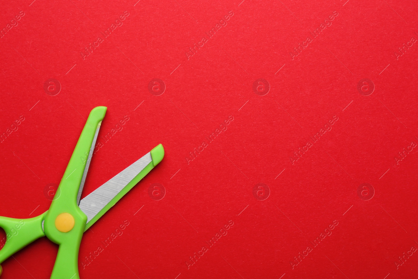 Photo of Training scissors on color background, top view. Space for text