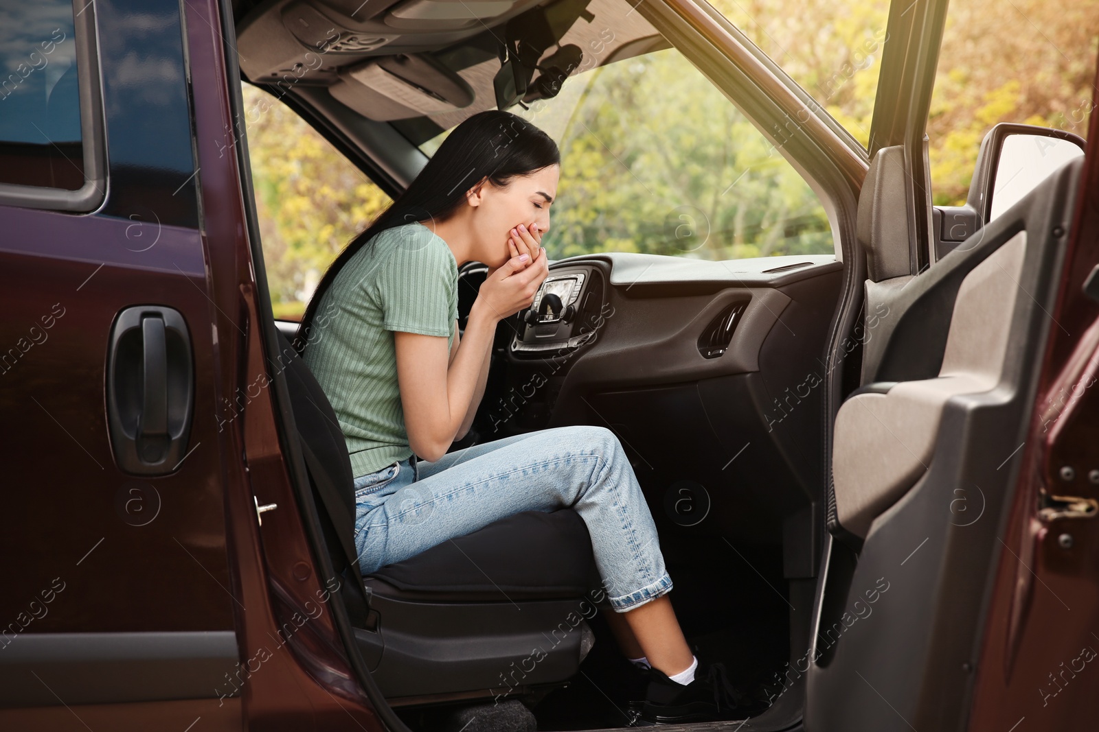 Photo of Young woman suffering from nausea in car