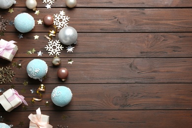 Flat lay composition with Christmas decorations on wooden background, space for text. Winter season