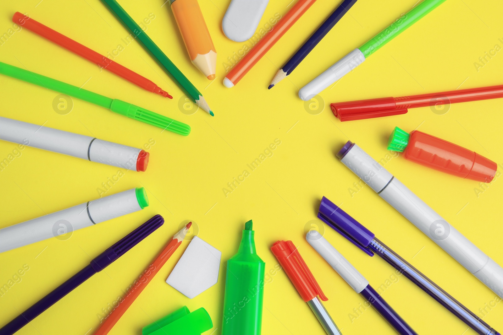 Photo of Frame of different school stationery on yellow background, flat lay with space for text. Back to school