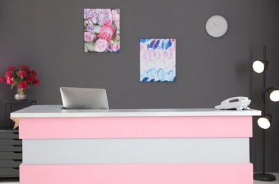 Photo of Beauty salon interior with computer on desk. Receptionist workplace