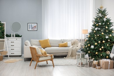 Photo of Christmas tree in furnished living room. Festive interior design