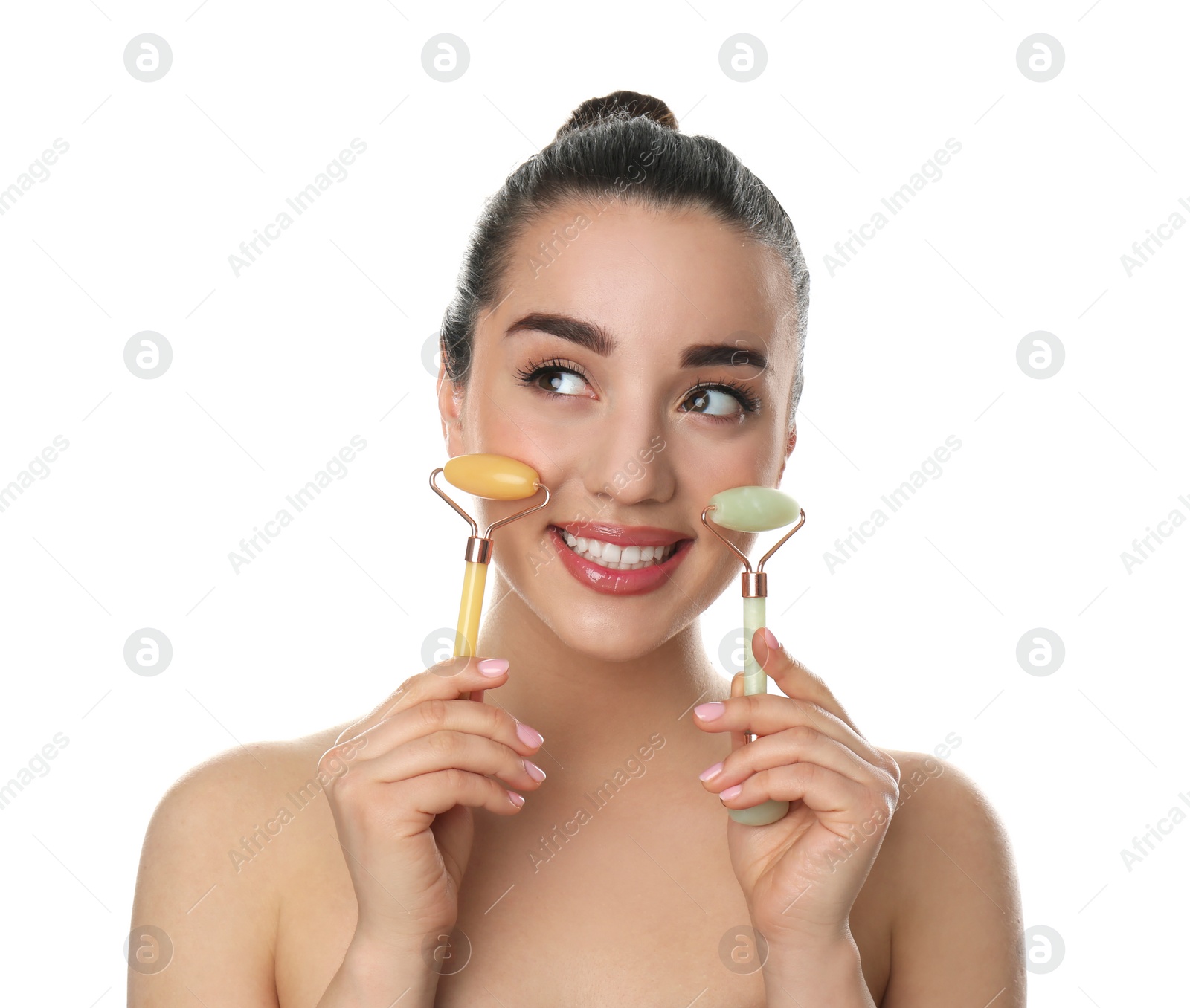 Photo of Woman with natural face jade rollers on white background