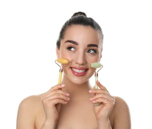 Photo of Woman with natural face jade rollers on white background