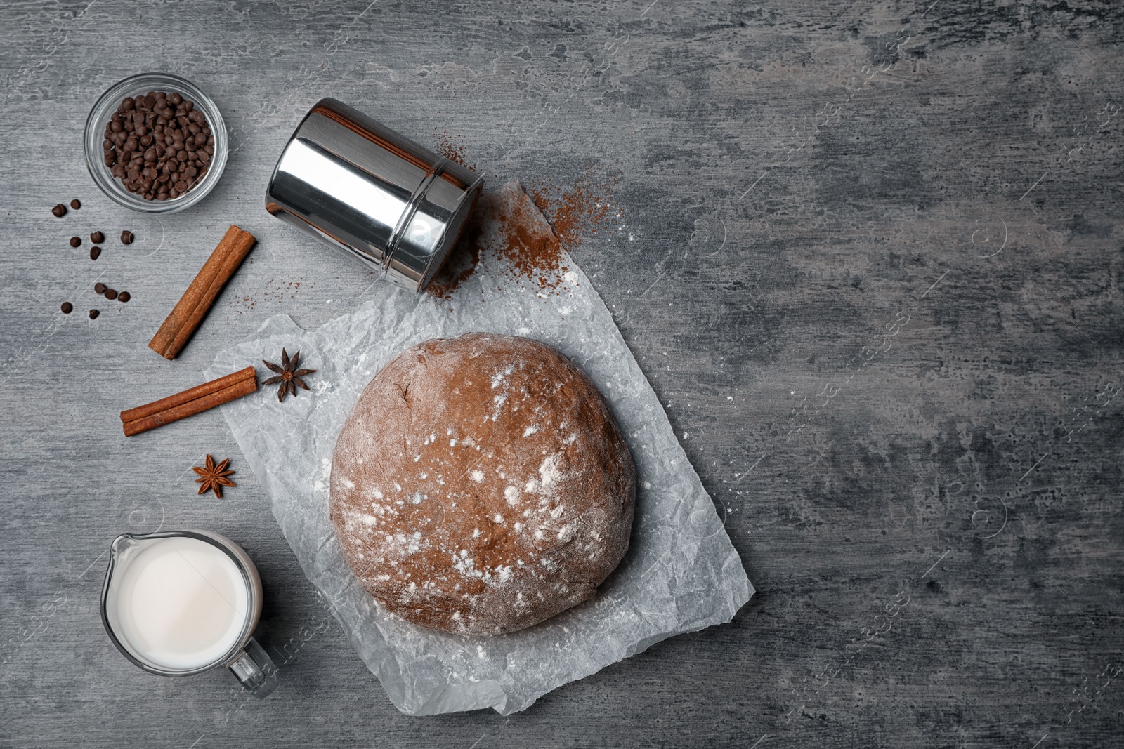 Photo of Flat lay composition with raw dough and products on grey background