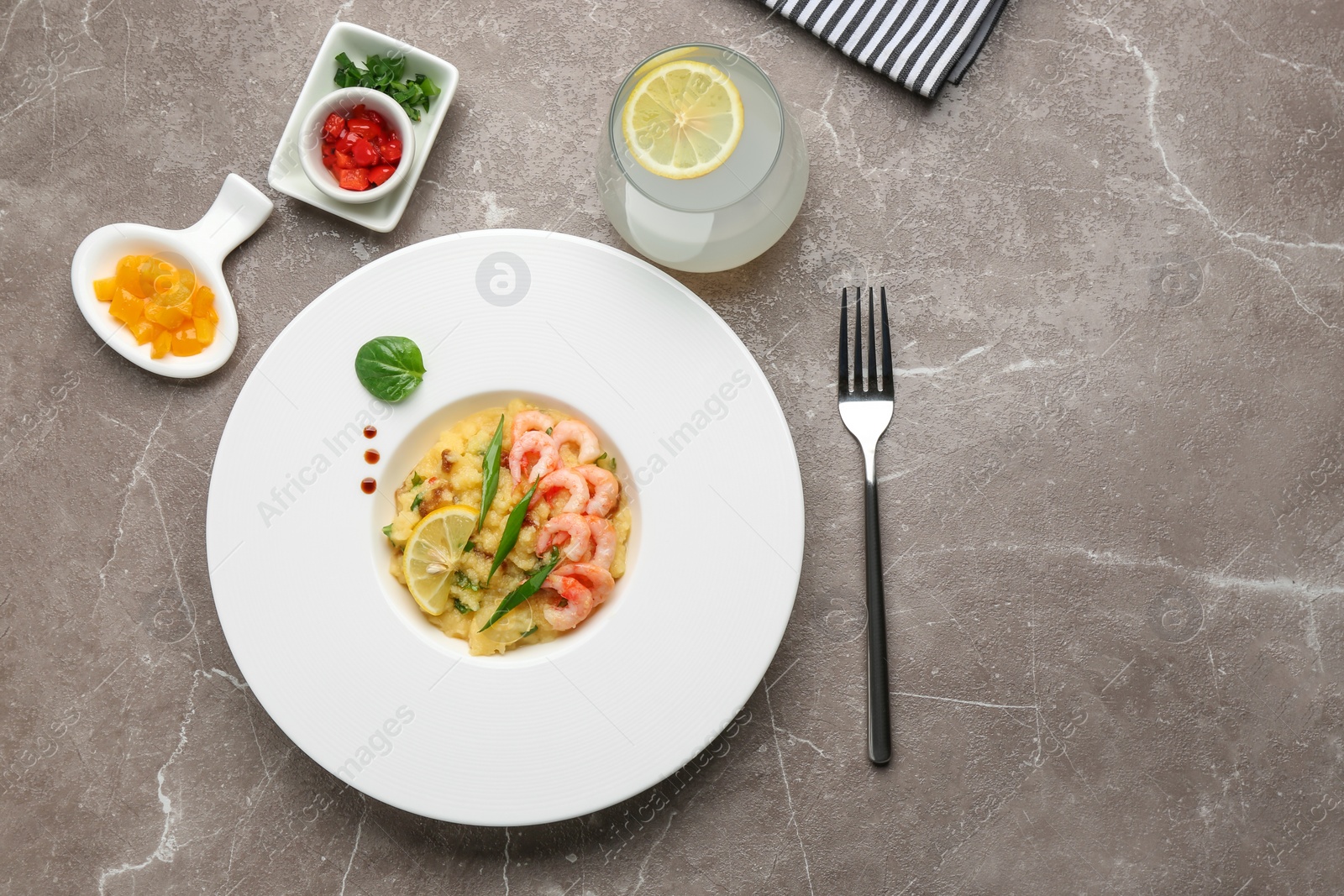 Photo of Plate with tasty shrimps and grits on table