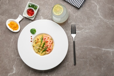 Plate with tasty shrimps and grits on table