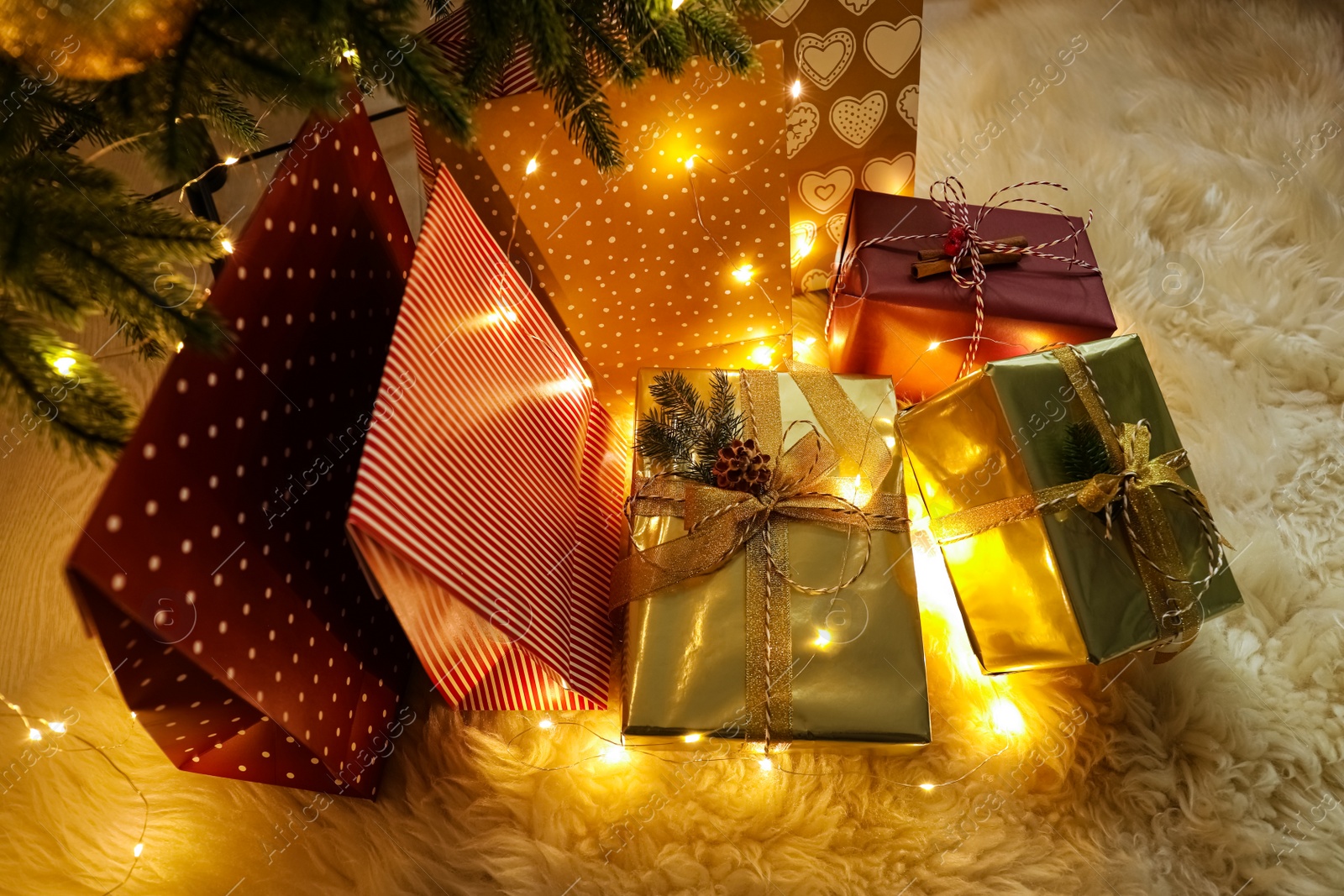 Photo of Many different gifts under Christmas tree, above view