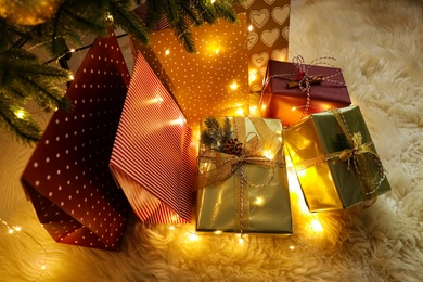 Photo of Many different gifts under Christmas tree, above view
