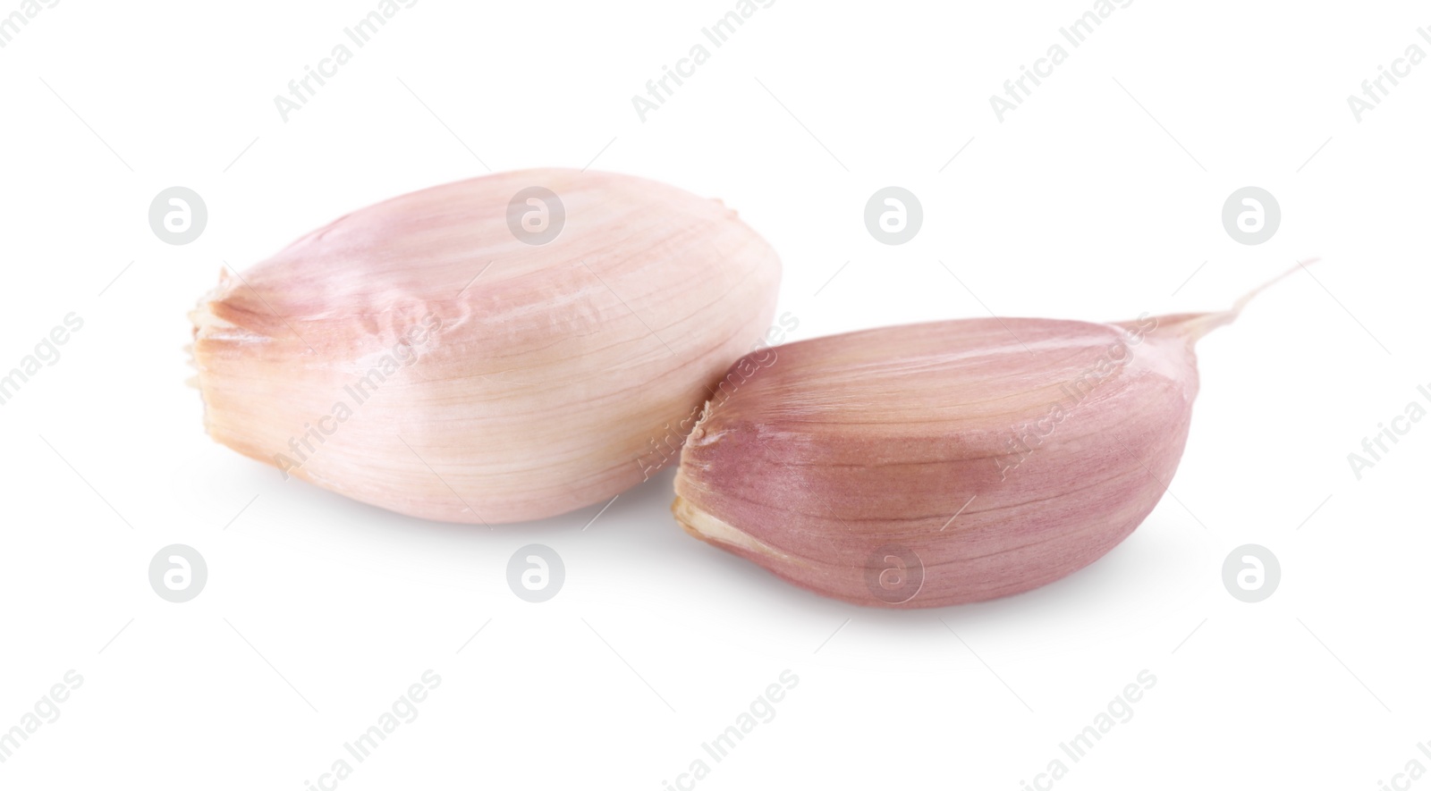Photo of Unpeeled cloves of fresh garlic isolated on white