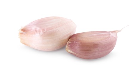 Photo of Unpeeled cloves of fresh garlic isolated on white