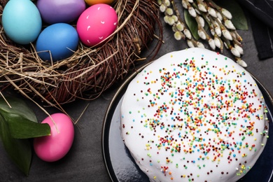 Photo of Flat lay composition with traditional Easter cake on black table