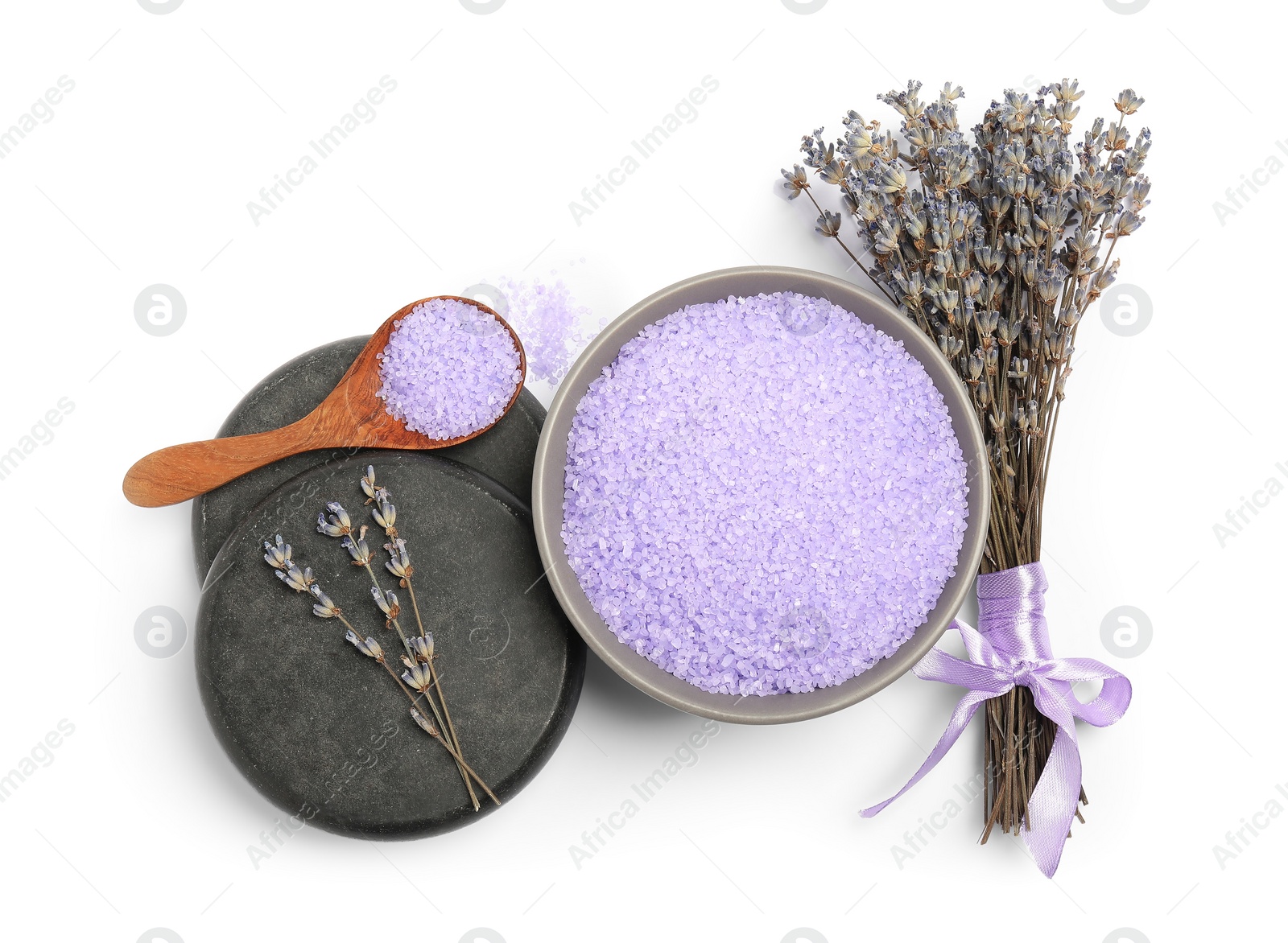 Photo of Violet sea salt in bowl, spa stones, spoon and lavender flowers isolated on white, top view
