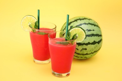 Delicious drink with mint, lime and fresh watermelon on yellow background