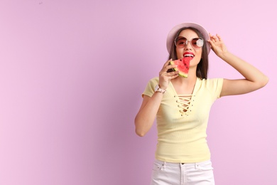 Photo of Beautiful young woman posing with watermelon on color background