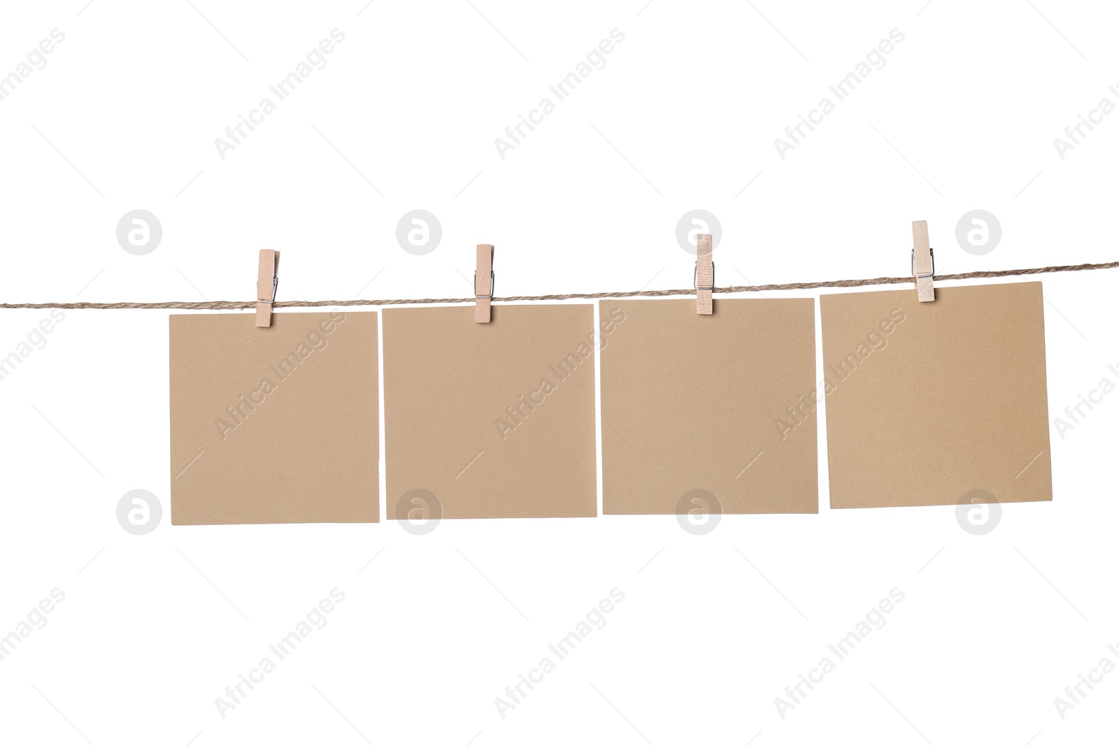 Photo of Clothespins with empty notepapers on string against white background. Space for text