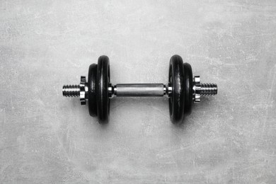 Photo of One barbell on grey textured background, top view