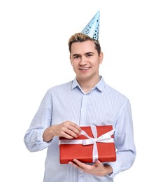 Photo of Young man with party hat and gift box on white background