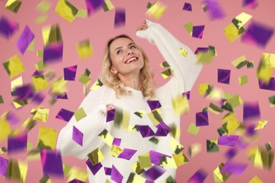 Image of Happy woman under falling confetti on pink background