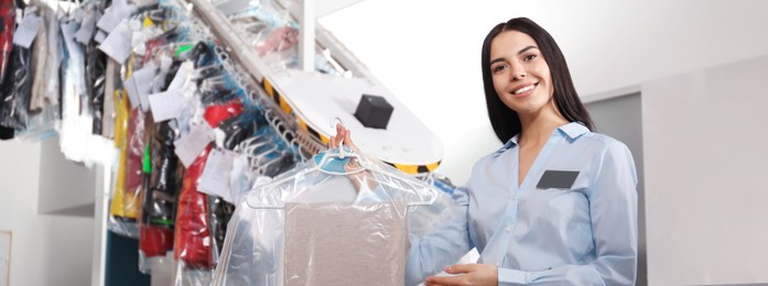 Female worker with clean clothes, banner design. Dry-cleaning service