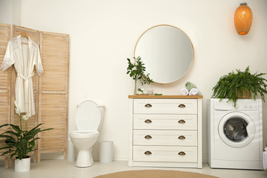 Elegant interior of modern bathroom with green plants