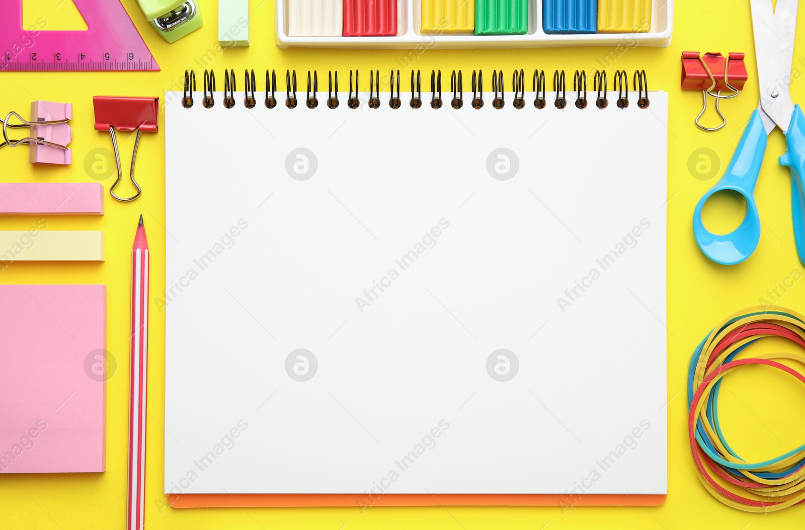 Photo of Flat lay composition with different school stationery on yellow background, space for text. Back to school