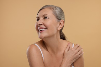 Photo of Beautiful woman with healthy skin on beige background