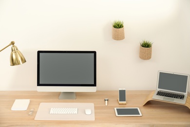 Stylish workplace interior with modern computer on table. Mockup for design