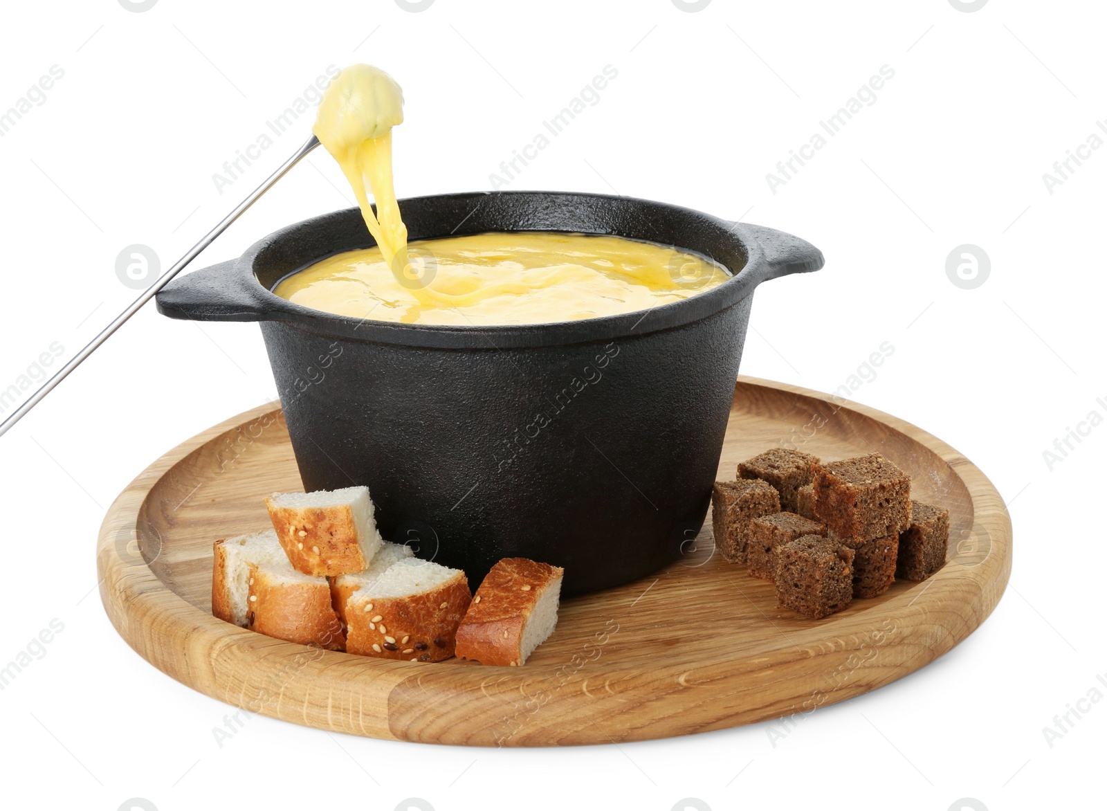 Photo of Dipping piece of bread into fondue pot with tasty melted cheese isolated on white