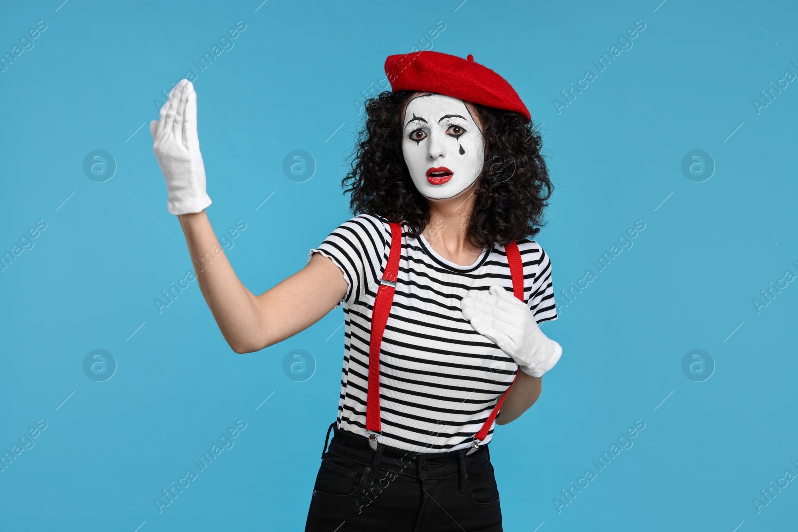 Photo of Sad mine with beret posing on light blue background