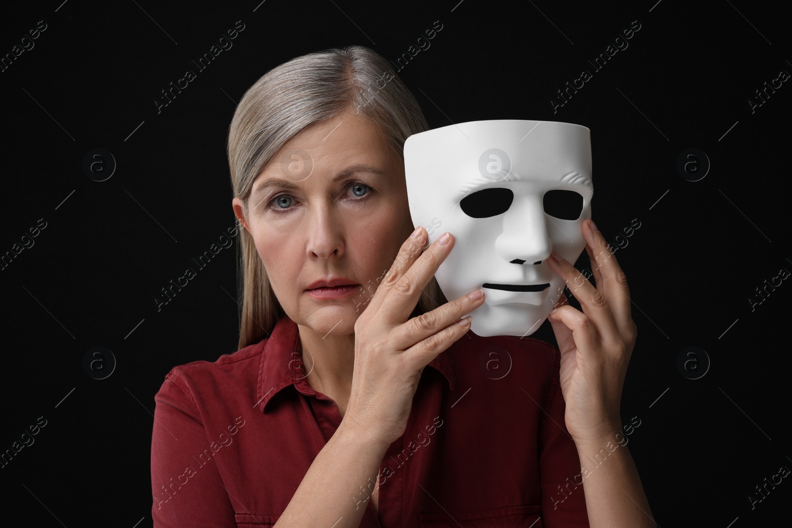 Photo of Multiple personality concept. Woman with mask on black background