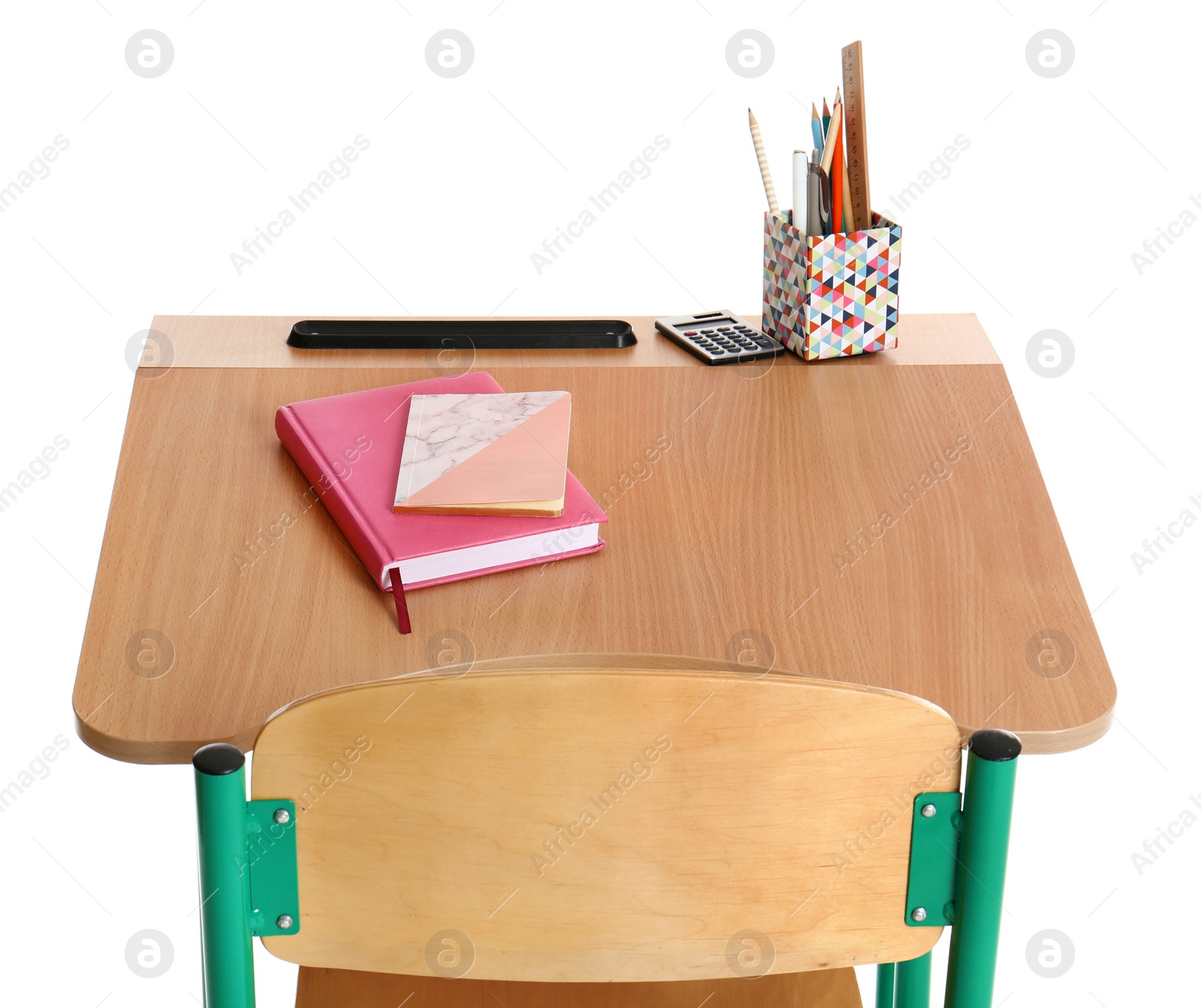 Photo of Wooden school desk with stationery on white background