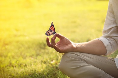 Man meditating outdoors on sunny day, closeup. Space for text