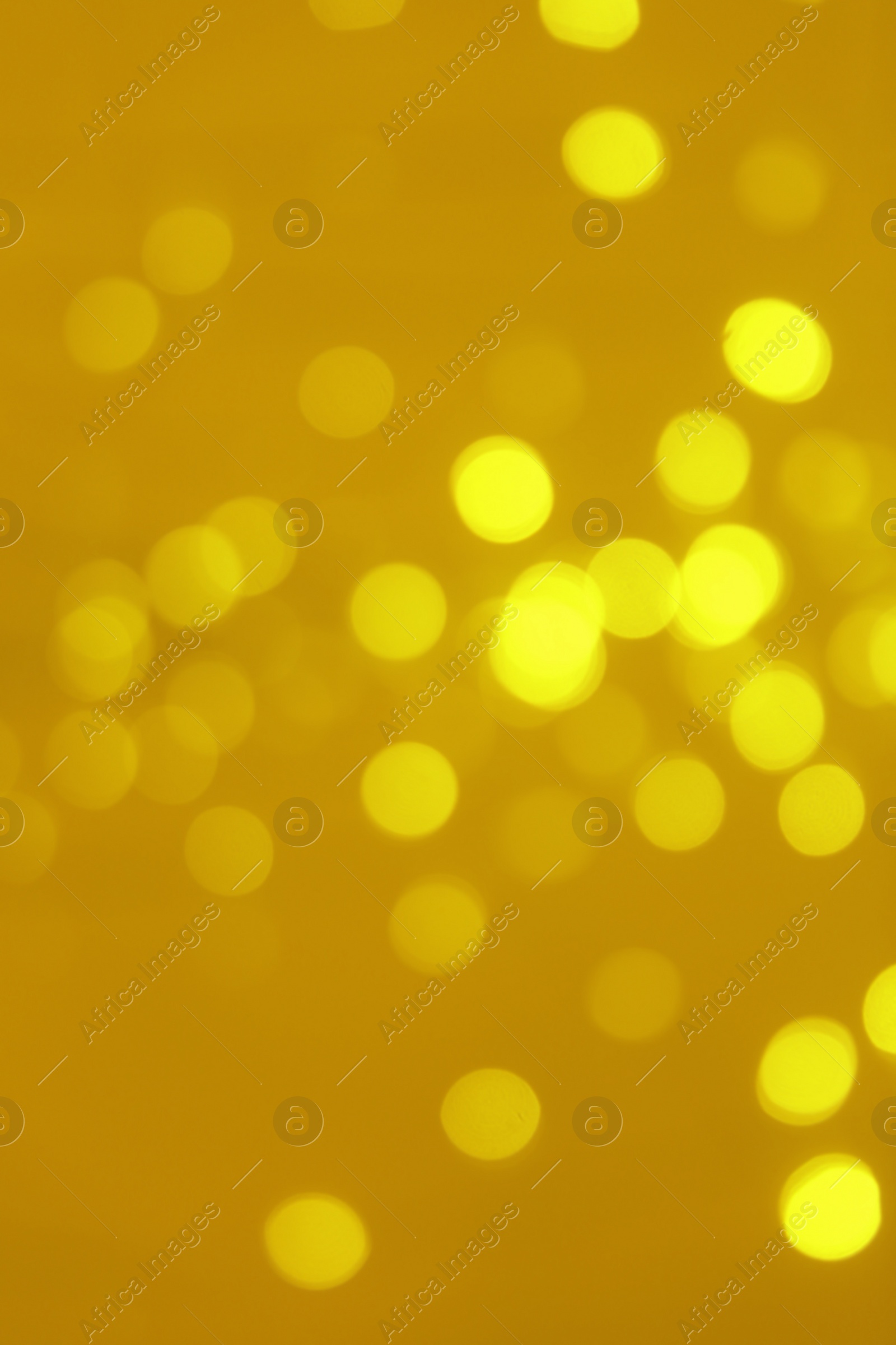 Photo of Blurred view of shiny gold lights. Bokeh effect