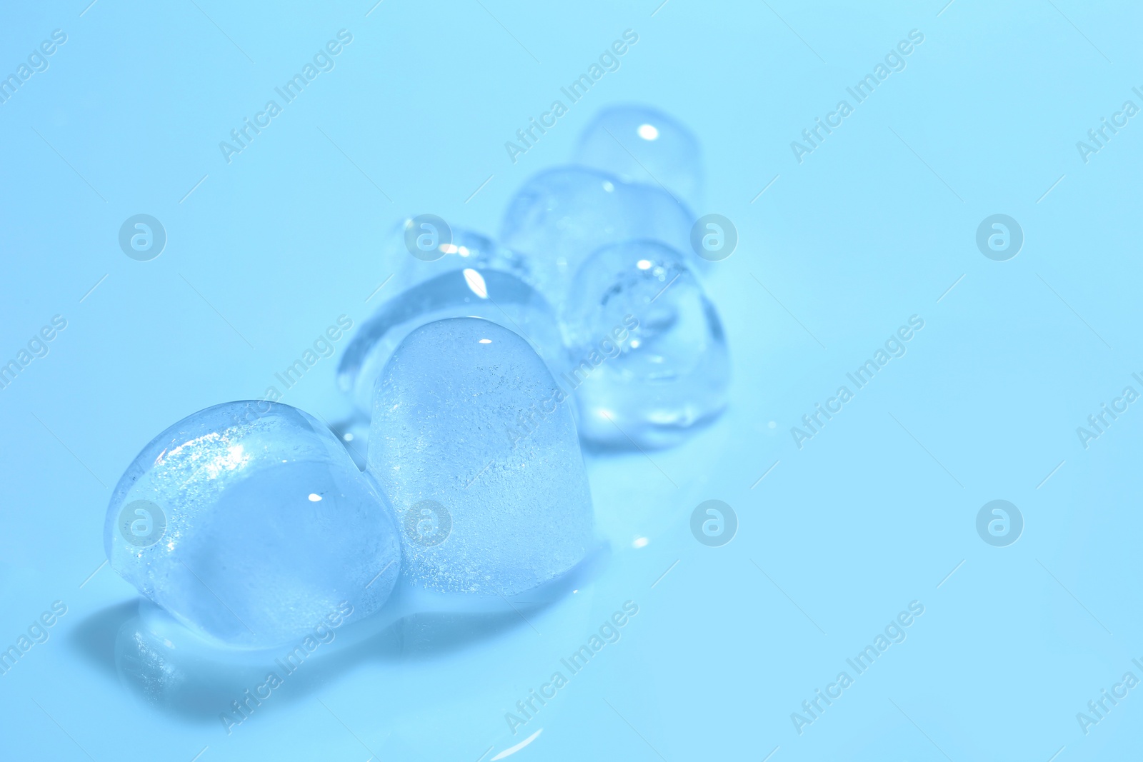 Photo of Ice cubes on color background. Space for text