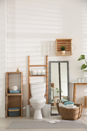 Photo of Interior of stylish bathroom with toilet bowl and decor elements