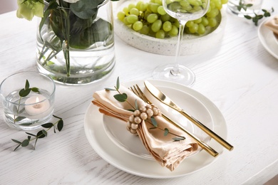 Elegant festive table setting on white wooden table