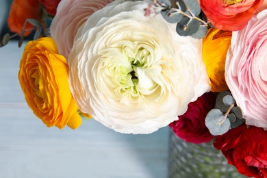 Photo of Bouquet with beautiful ranunculus flowers on table, closeup