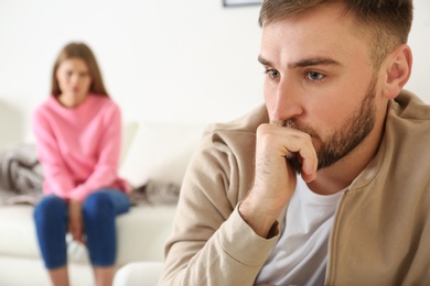 Young couple ignoring each other after argument in living room. Relationship problems