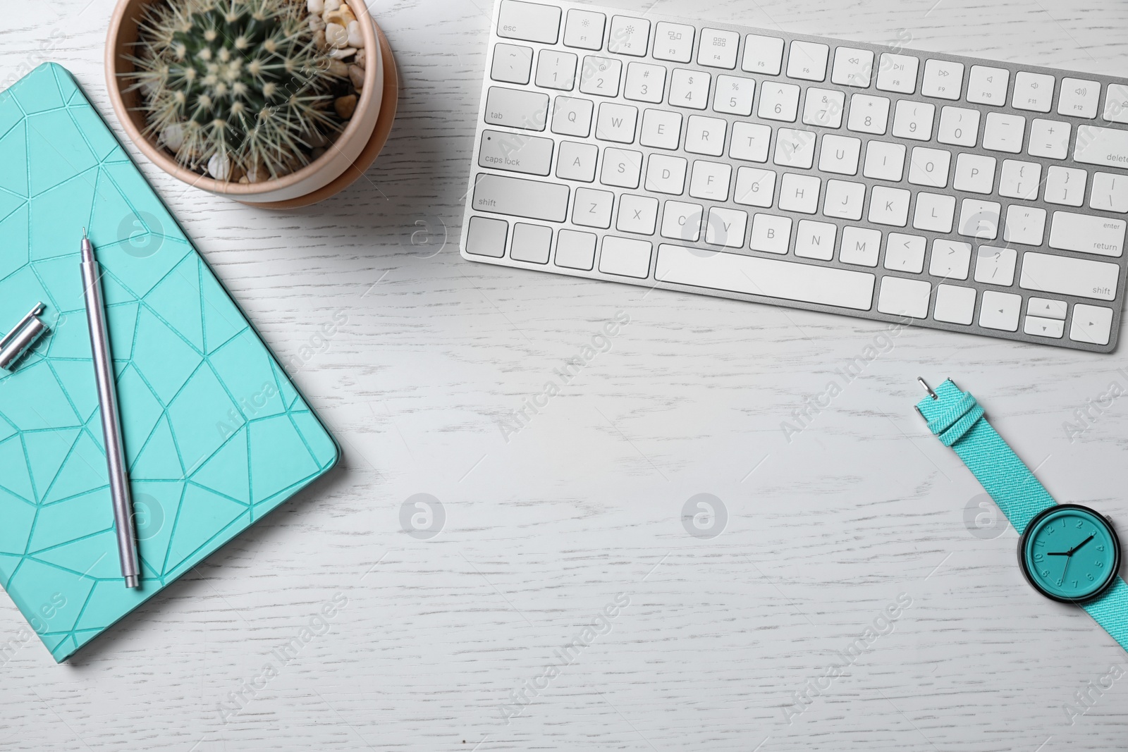 Photo of Flat lay composition keyboard, cactus and notebook on white wooden table, space for text. Blogger's workplace