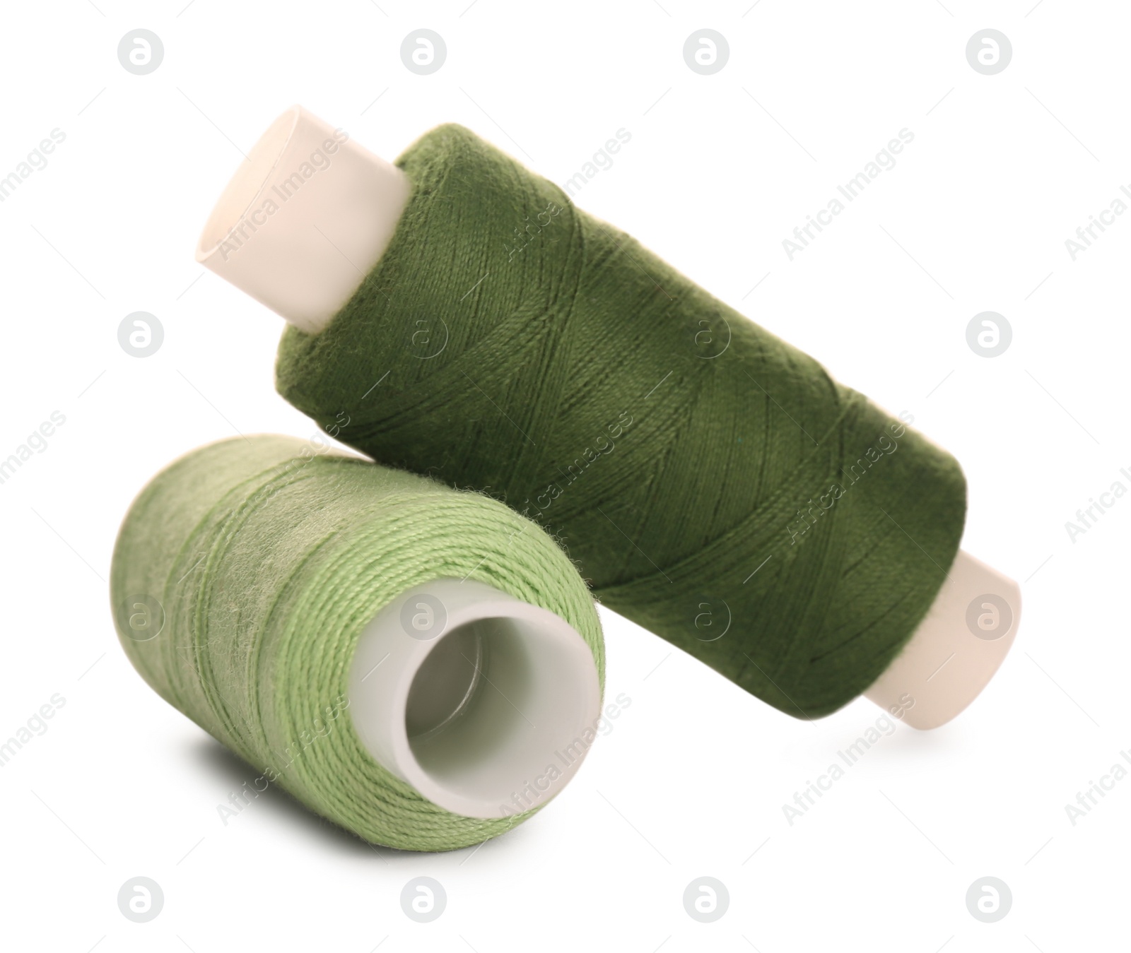 Photo of Different colorful sewing threads on white background