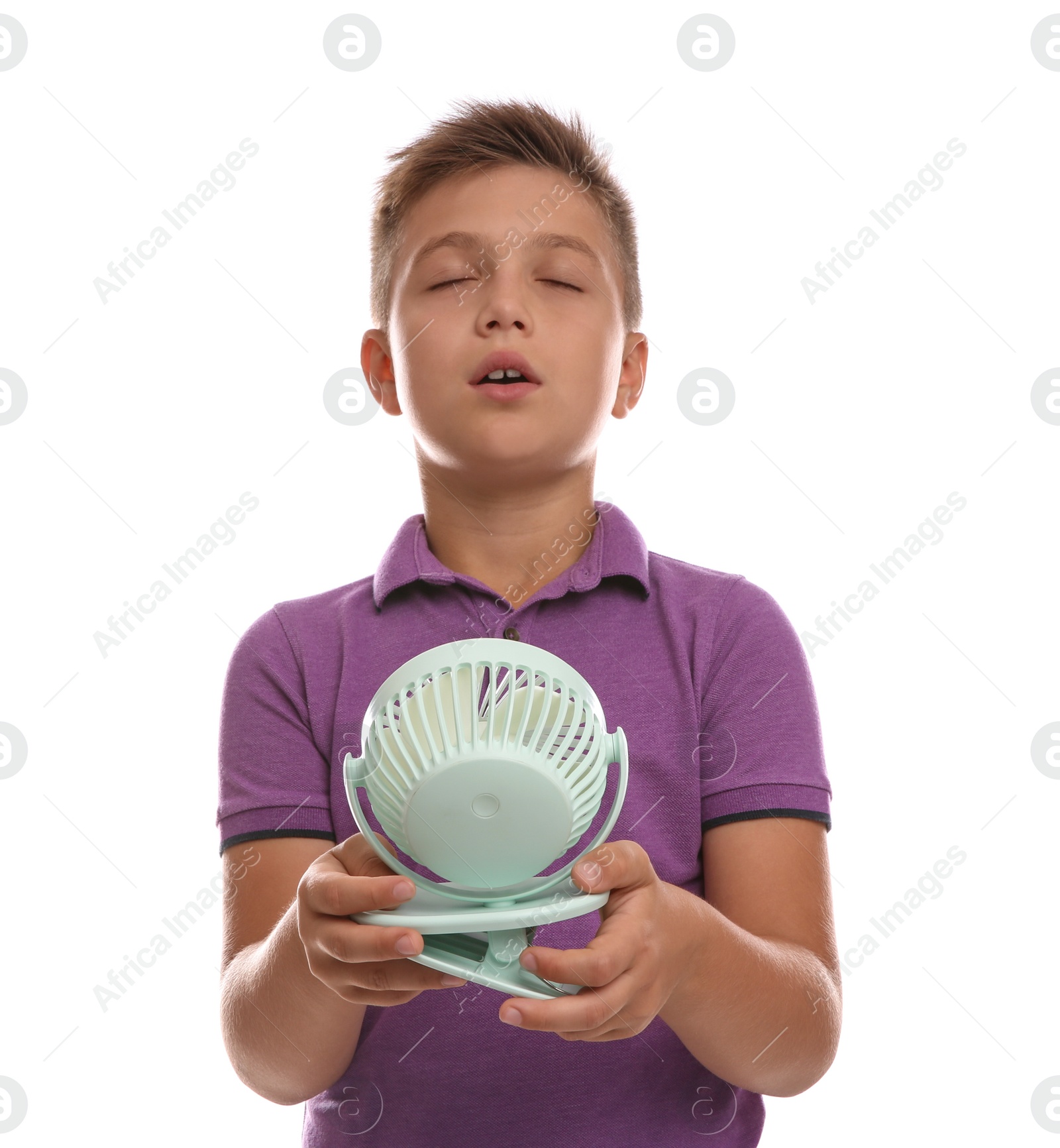 Photo of Little boy enjoying air flow from portable fan on white background. Summer heat