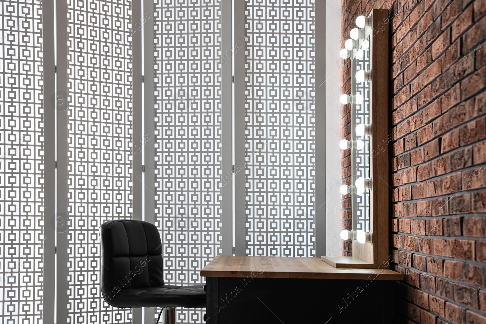 Photo of Makeup room interior with wooden table and large mirror