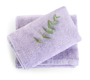 Violet terry towels and eucalyptus branch isolated on white, top view