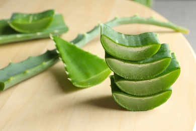 Photo of Fresh sliced aloe vera leaves on light table