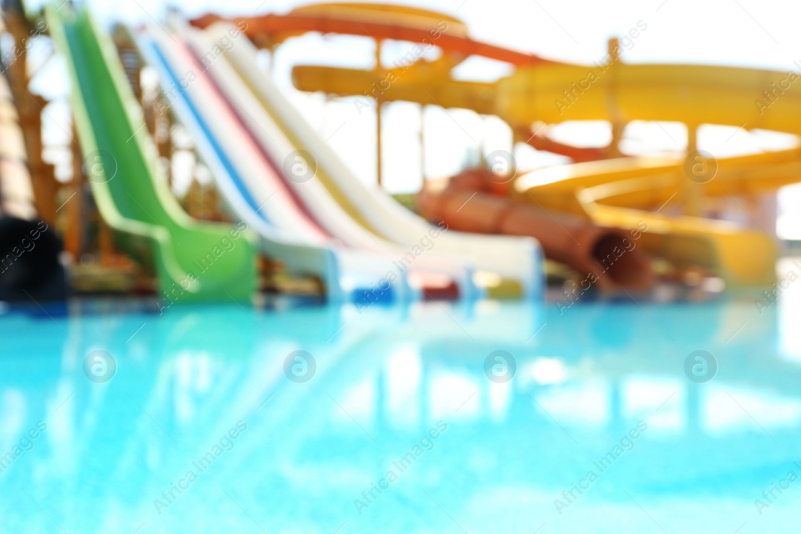 Photo of Different colorful slides in water park, blurred view