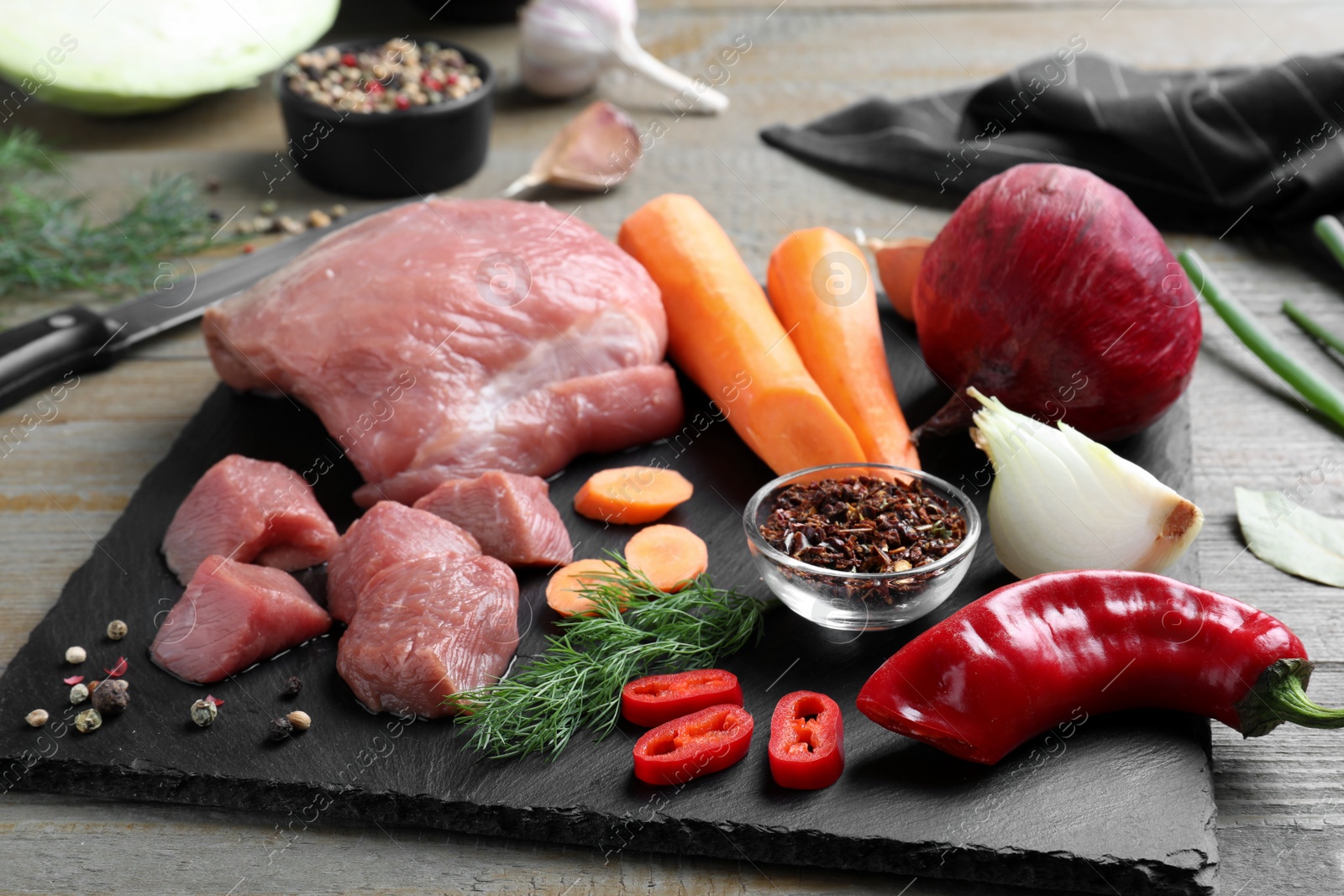 Photo of Fresh ingredients for borscht on wooden table