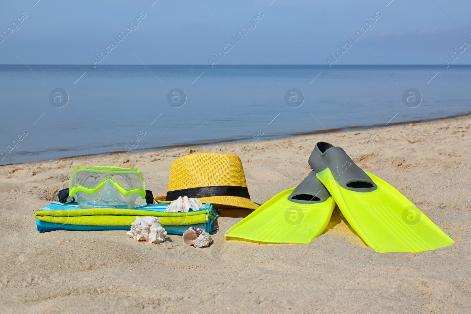 Photo of Set of different stylish beach accessories on sand. Space for text